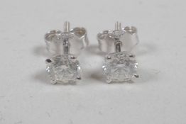 A pair of diamond stud earrings, approximately 1.1ct, on white gold posts