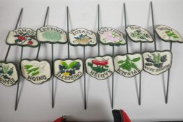 A set of twelve painted cast metal garden/allotment plant markers, 4½" wide