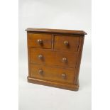 A C19th walnut apprentice chest of two short over two long drawers, 9" x 9" x 4½"