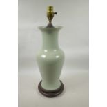 An Oriental celadon crackle glazed porcelain vase on a hardwood stand, converted to electricity, 23"
