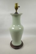 An Oriental celadon crackle glazed porcelain vase on a hardwood stand, converted to electricity, 23"