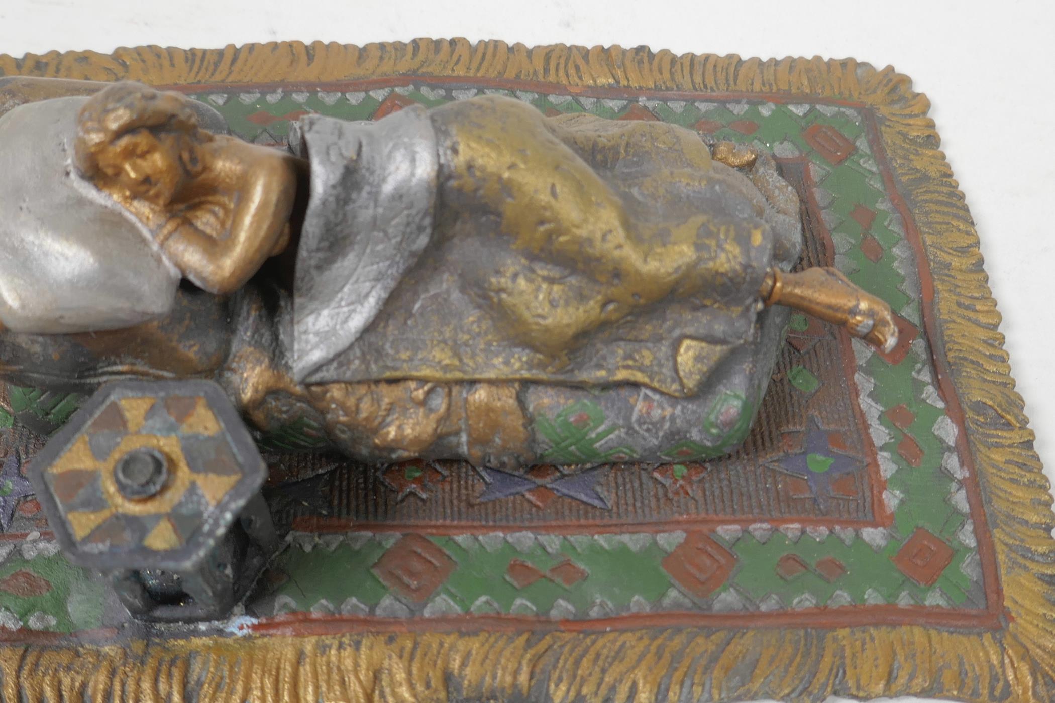 A cold painted bronze figure of a girl lying on a bed, 6¼" long - Image 2 of 4