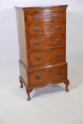 A Bevan Funnell, Reprodux burr walnut bowfronted tallboy chest of five drawers, raised on cabriole