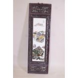 A Chinese famille vert porcelain panel in a carved and pierced hardwood frame, decorated with
