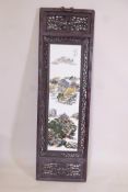 A Chinese famille vert porcelain panel in a carved and pierced hardwood frame, decorated with