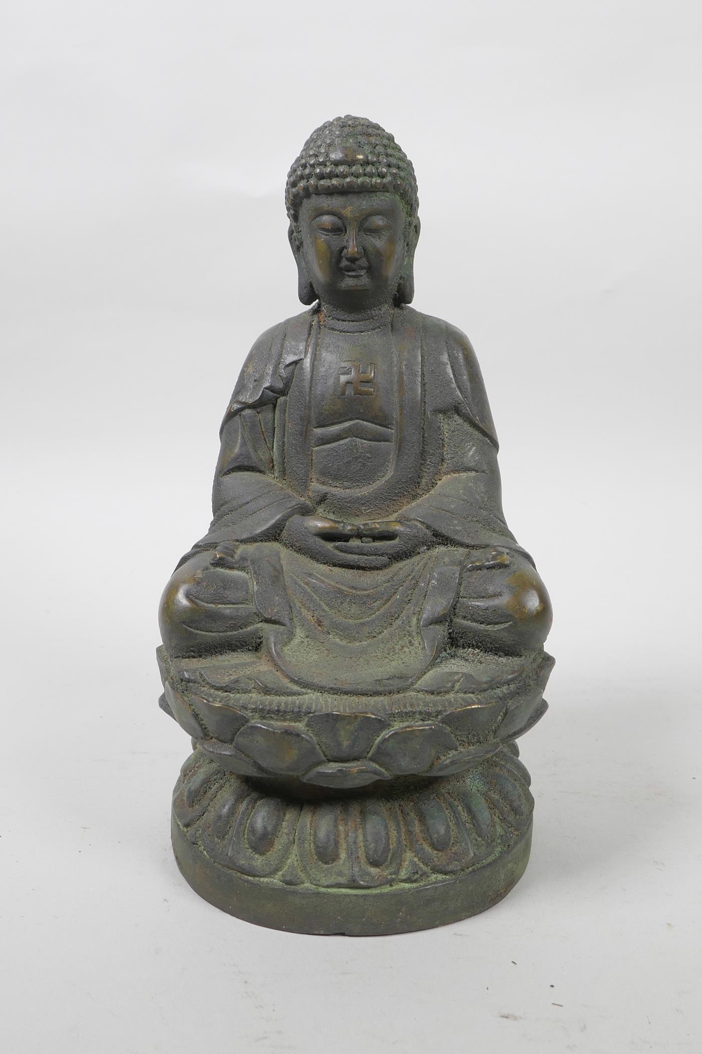 A bronze of Buddha seated on a lotus throne with verdigris patina, 8" high