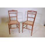 A pair of Edwardian walnut bedroom chairs with cane seats, 32" high