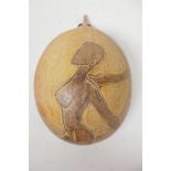A carved half shell decorated with a stylised nude lady, signed John Cooper 1991, 9" long