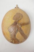 A carved half shell decorated with a stylised nude lady, signed John Cooper 1991, 9" long