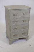 A painted and gilt bedside chest of four drawers on bracket feet, 17" x 12½", 27" high