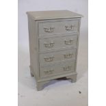 A painted and gilt bedside chest of four drawers on bracket feet, 17" x 12½", 27" high