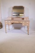 A pine kneehole dressing table with shaped swing mirror, over five drawers, on turned and fluted