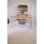 A pine kneehole dressing table with shaped swing mirror, over five drawers, on turned and fluted