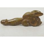 A carved hardstone phallic ornament with stylised rabbit base, 5" long