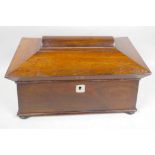 A rosewood sarcophagus shaped tea caddy with two inner compartments and mixing bowl, 13" wide