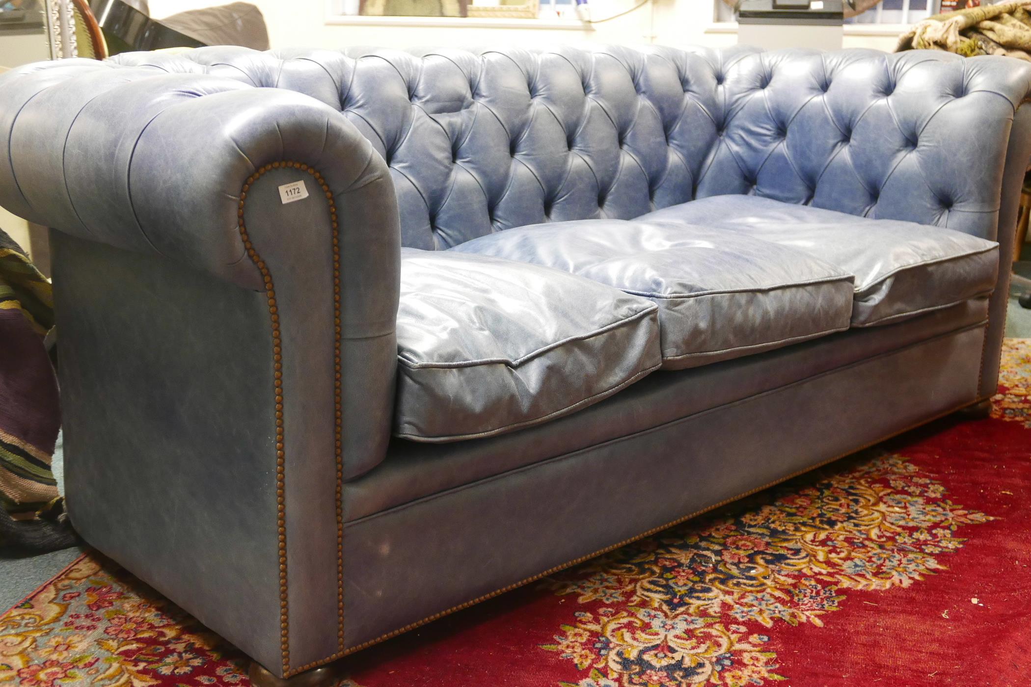 A blue leather high back Chesterfield three seater sofa, 88" x 42", 33" high