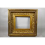 A good early C19th composition picture frame having concave leaf decoration, six inch wide