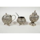 A late Victorian Anglo-Indian solid silver (tested) three piece condiment set, with embossed