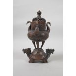 A Chinese coppered metal burner in the form of a censer on the back of a dragon tortoise, with three