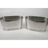 A pair of oval plated champagne coolers engraved with aphorisms from Lily Bollinger and Napoleon, 6"