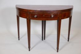 A C19th inlaid mahogany demilune fold over card table, with single frieze drawer on square tapered