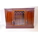 A Victorian mahogany bookcase with crossbanded inlay, and two doors flanking a glazed centre