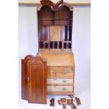 A Georgian inlaid walnut fall front bureau bookcase, the double domed top with two doors opening