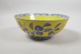 A Chinese Ming style yellow ground porcelain bowl with blue and white lotus flower and fruit