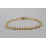 A 14ct yellow gold diamond line bracelet, 6" long, approximately 2.3cts