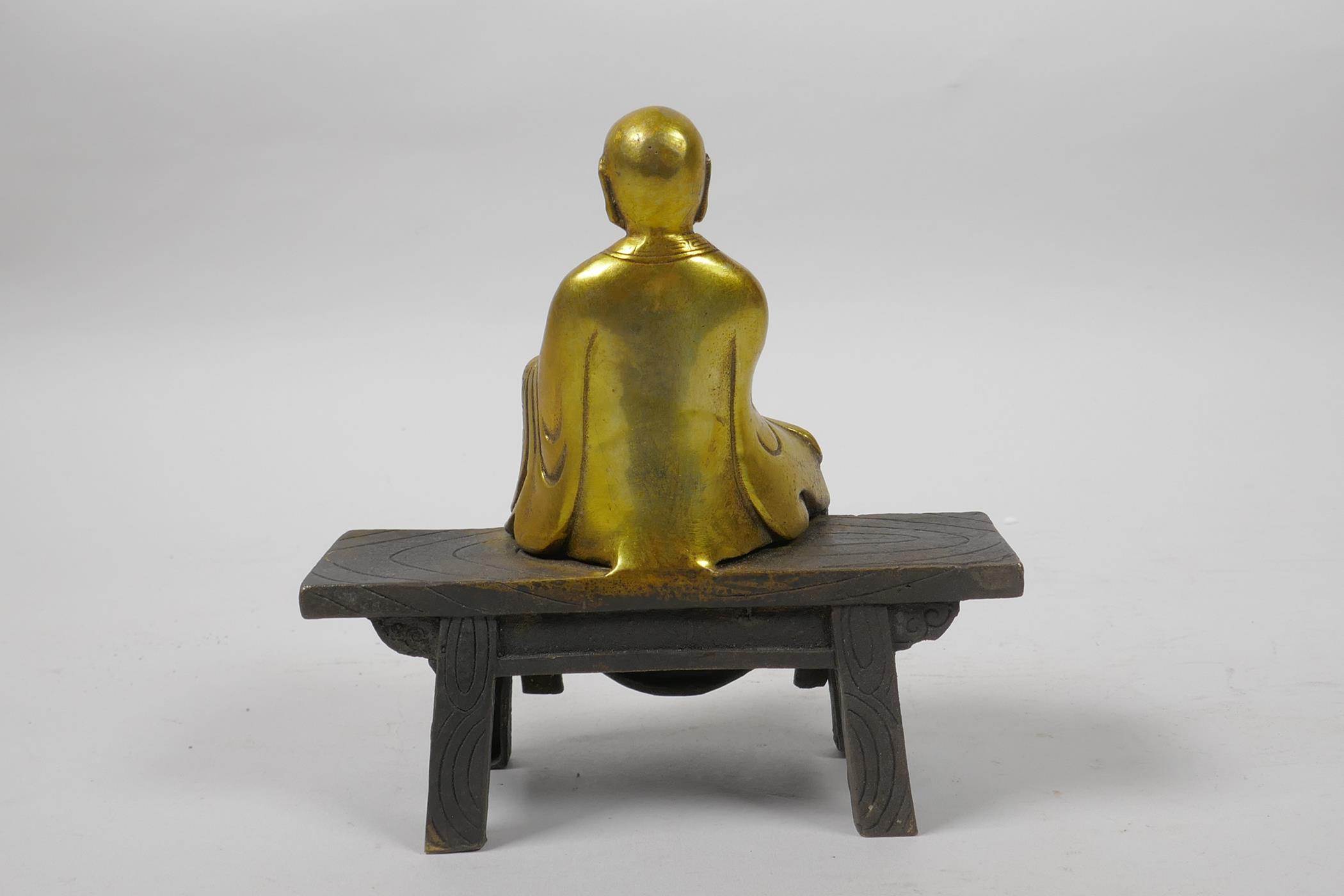 A Chinese gilt bronze figure of Buddha seated on a bench, 5½" high - Image 2 of 3