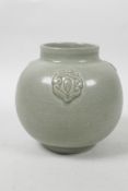 A Chinese Song style celadon glazed pot with raised decoration, 4½" high