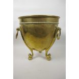 A Soutterware brass jardiniere with three ring handles and heavy cast scroll legs, 12" high, 11½"