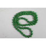 A long string of green jade beads, 32" long