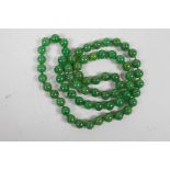A long string of green jade beads, 32" long