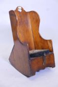 A C18th child's elm rocking chair and commode made in the style of a lambing chair, 27" high, seat