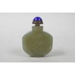 A Chinese celadon jade snuff bottle with carved floral decoration, character inscription verso,