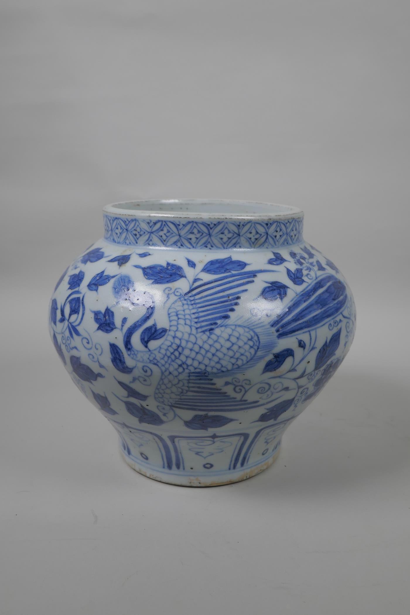 A Chinese blue and white Yuan style jar decorated with phoenix and flowers, 8" high