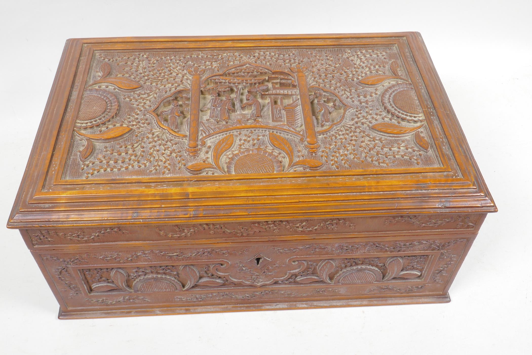 A Chinese carved hardwood box decorated with figures in a garden scene, 12¼" x 5¾" x 8"