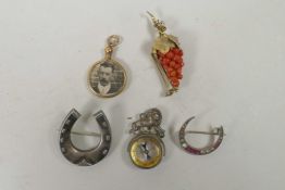 A hallmarked silver horseshoe brooch, a coral and silver gilt brooch in the form of a bunch of