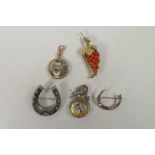 A hallmarked silver horseshoe brooch, a coral and silver gilt brooch in the form of a bunch of