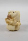 A bone tape measure carved in the form of a bear, 2" high