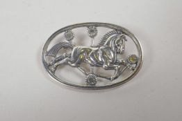 A Danish sterling silver brooch decorated with a horse, 1½" wide