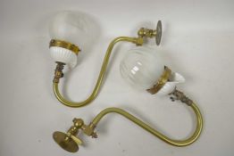 A pair of brass swan neck gas mantles with glass shades, 12" wide