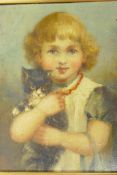 An oil on board portrait of a young girl with a kitten in her arms, 7½" x 9½"