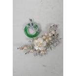 A silvered metal brooch in the form of a prunus blossom spray set with mother of pearl, pearls and