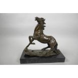 A bronze figurine of a horse posed with left foreleg raised after A.L. Barye, 9" high, mounted on