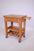 A pine butcher's block with a single drawer, slide and two wine rack under tiers, 26" x 19", 34"