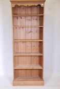 A pine open shelf bookcase with five adjustable shelves, 77" high, 28" wide, 12" deep