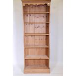 A pine open shelf bookcase with five adjustable shelves, 77" high, 28" wide, 12" deep