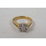 A 9ct yellow gold diamond set daisy style ring, approximate size 'N'